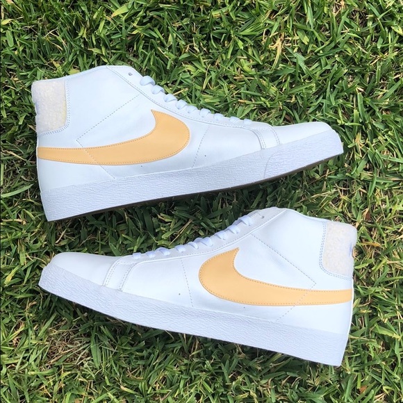 white and yellow nike high tops